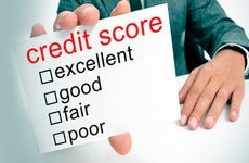 Male holding credit score card © iStock