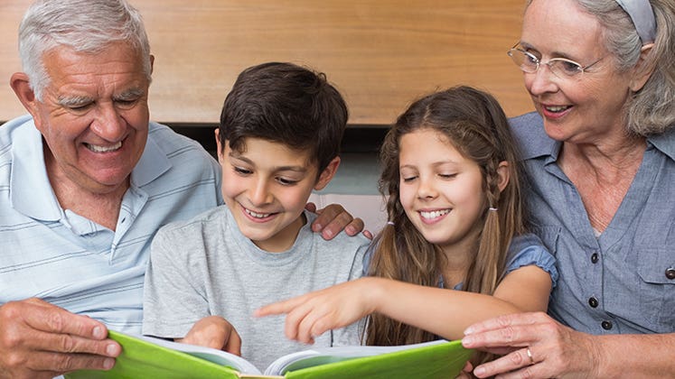 Grandparents reading with grandkids © wavebreakmedia/Shutterstock.com