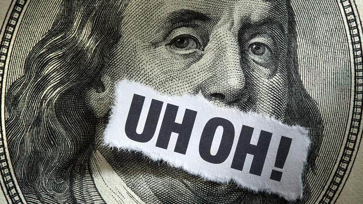 Ripped paper over $100 bill portrait's mouth | DNY59/E+/Getty Images