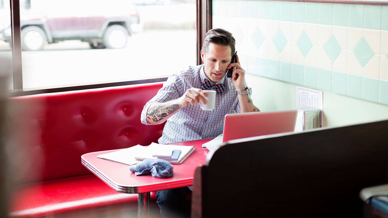 Man in a diner talking on the phone