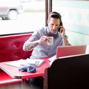 Man in a diner talking on the phone
