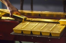 Person setting down gold bars