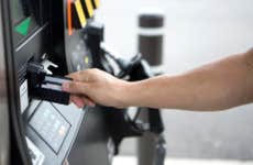 Person using debit card at gas station