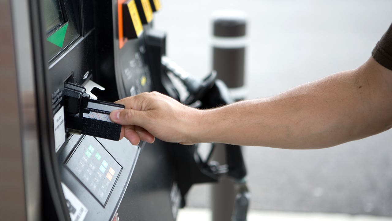 Person using debit card at gas station