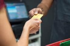 Credit card changing hands at point of sale