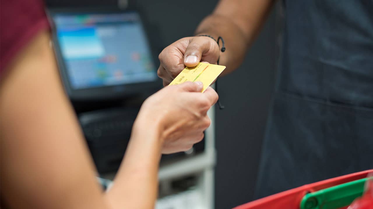 Credit card changing hands at point of sale