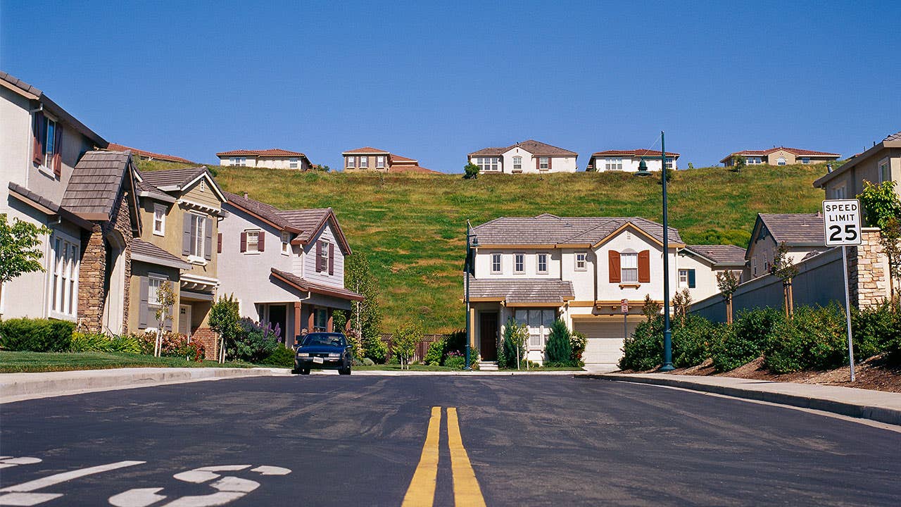 Suburban neighborhood with homes on a street and hill