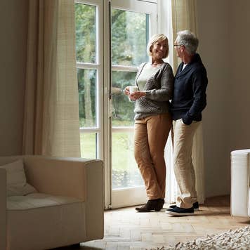 Older couple looking out of the window