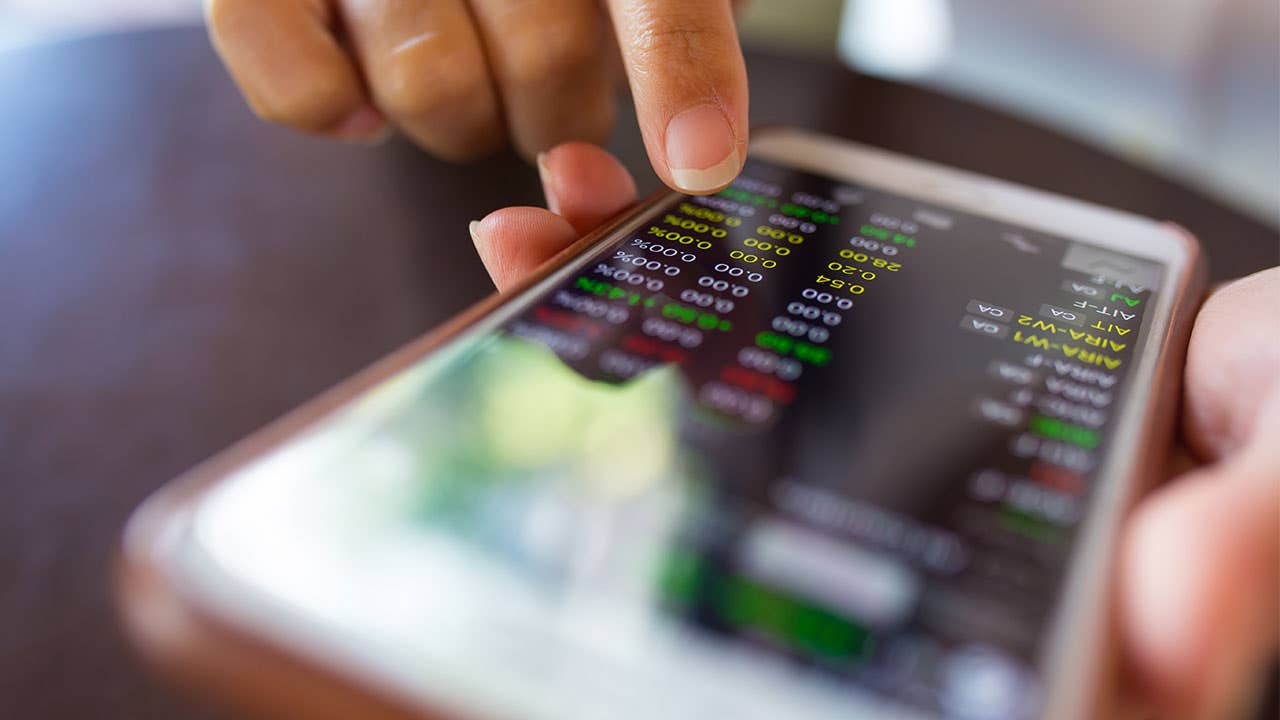 Woman using a financial app to check stocks