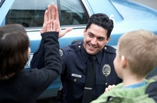 Policeman giving kid high five