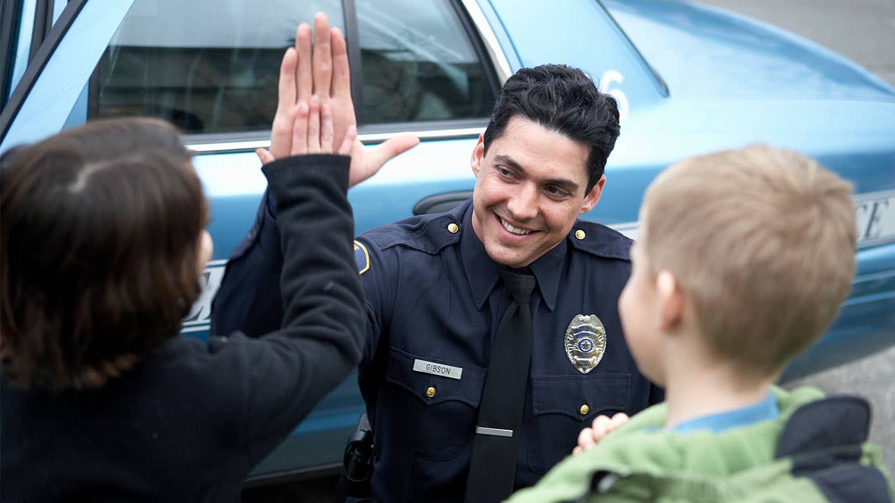 Policeman giving kid high five