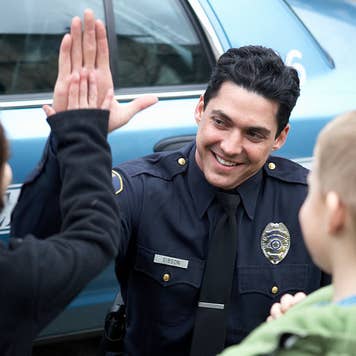 Policeman giving kid high five