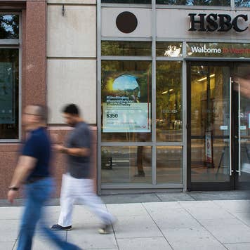 People walking past an HSBC Bank