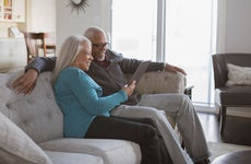 Couple using tablet in livingroom
