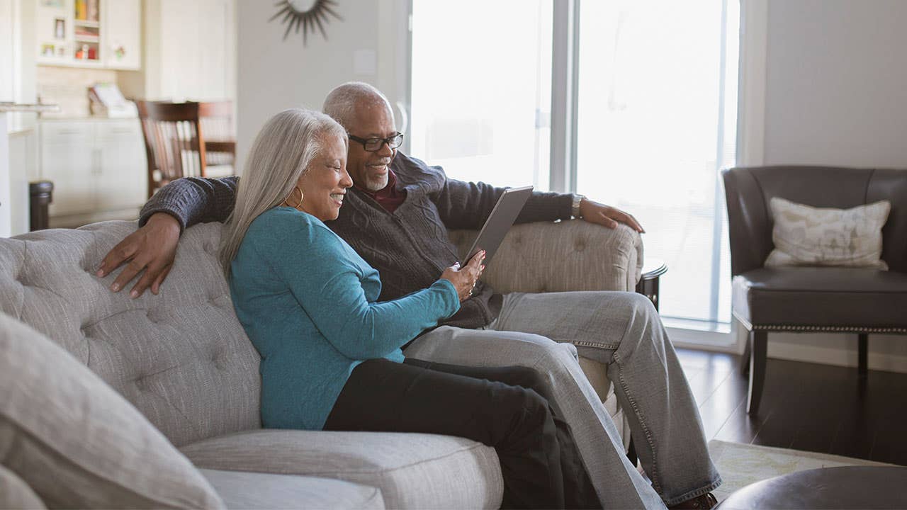 Couple using tablet in livingroom