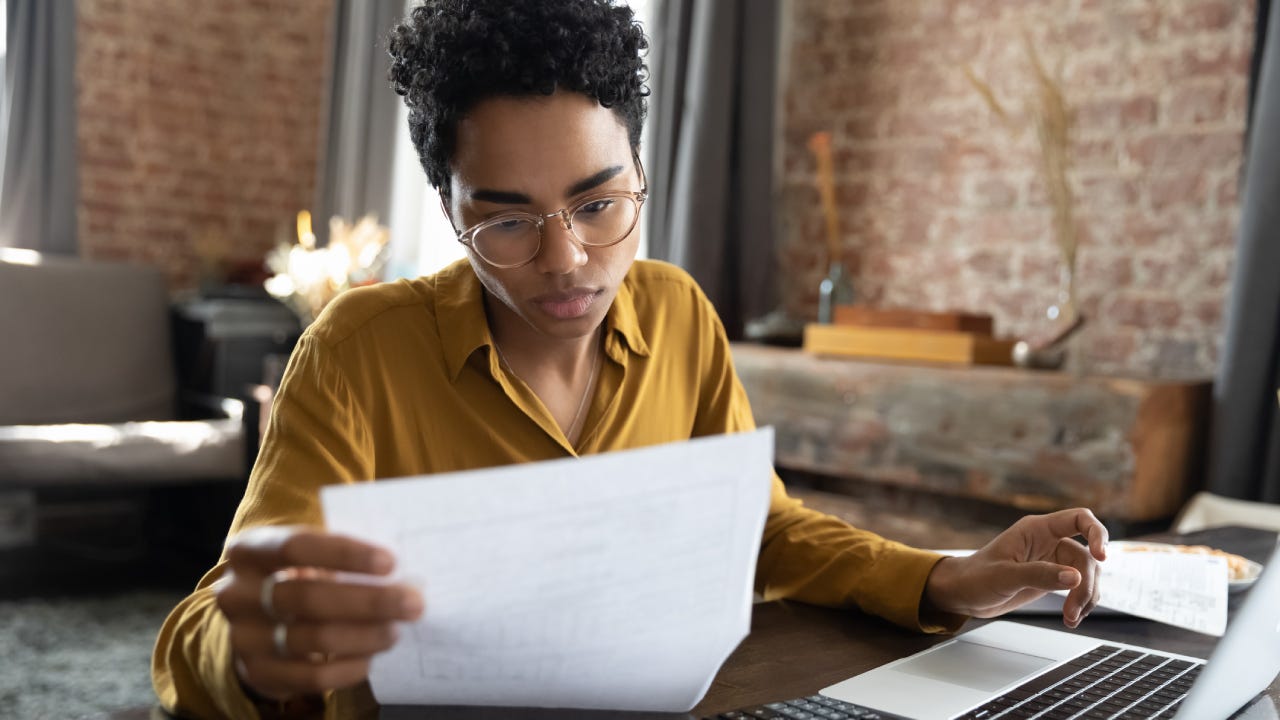 Focused young woman managing financial affairs