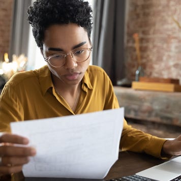Focused young woman managing financial affairs