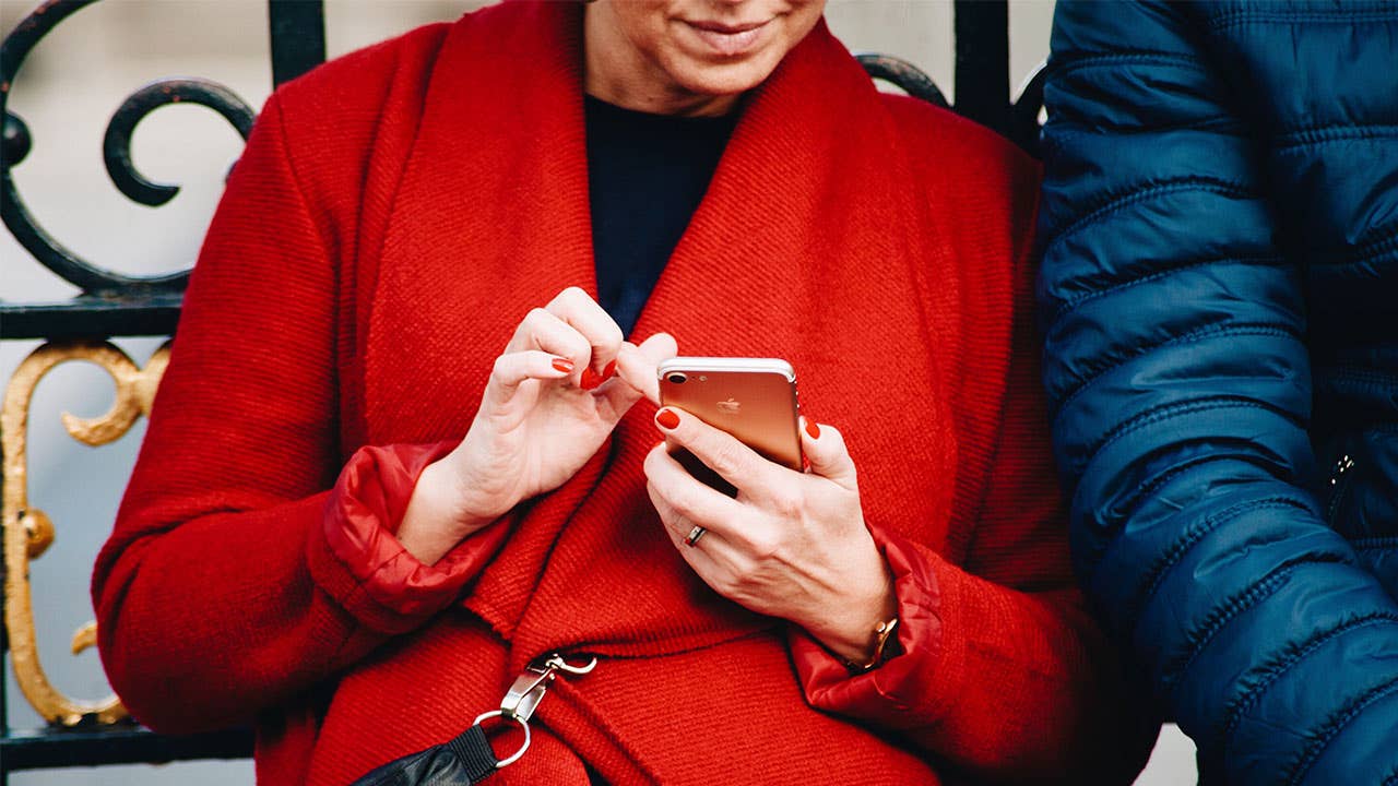 Woman in rd coat texting