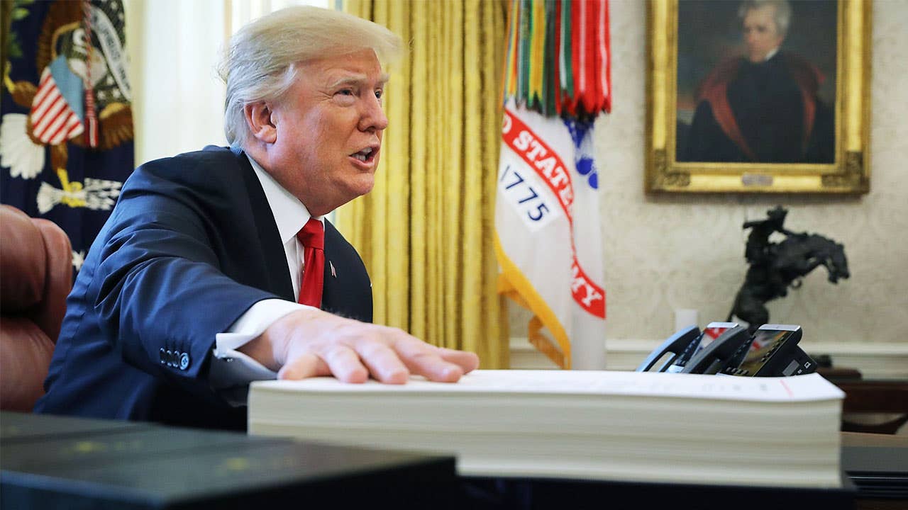 President Trump with tax reform documents