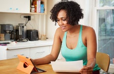 Woman looking at loan on tablet