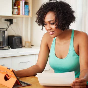 Woman looking at loan on tablet