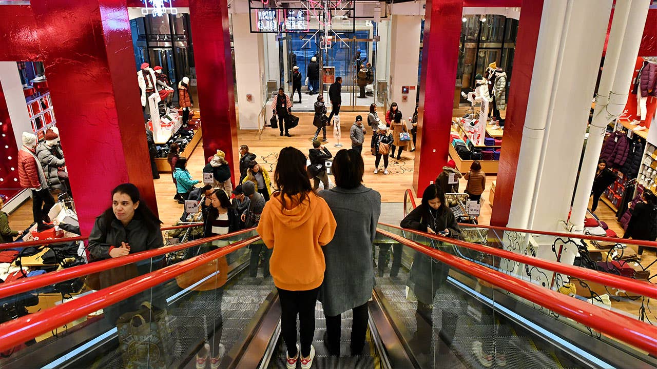 Shoppers ride an escalator in mall