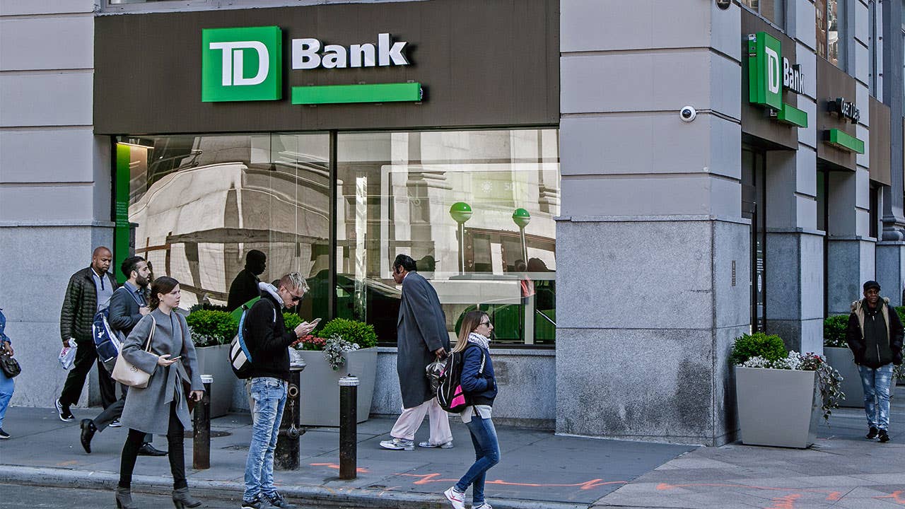 Pedestrians walking by TD Bank