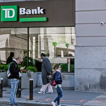 Pedestrians walking by TD Bank