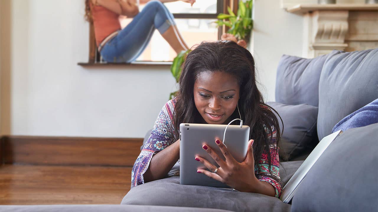 Woman on tablet looking at student loans