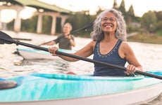 Seniors kayaking along a river