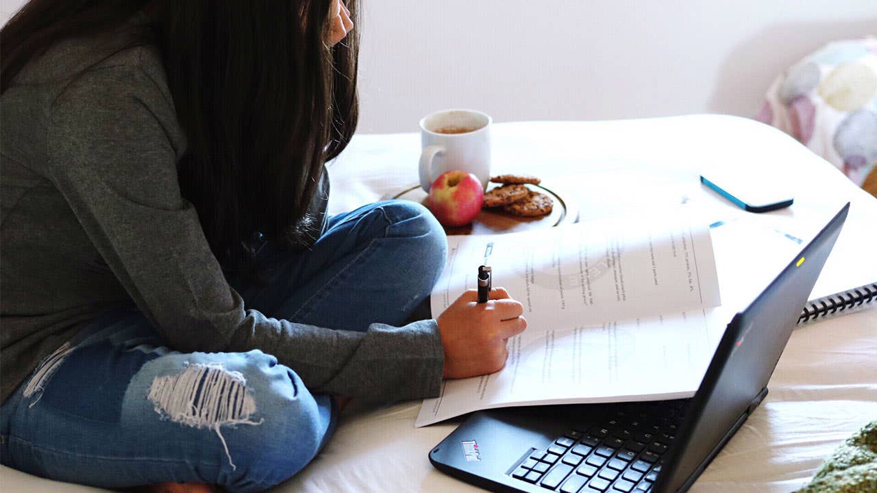 Student doing homework in dorm room