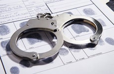 Set of handcuffs on top of fingerprint file
