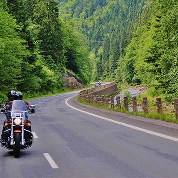 Couple motorcycling on the road
