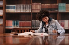 Young student studies in a college library