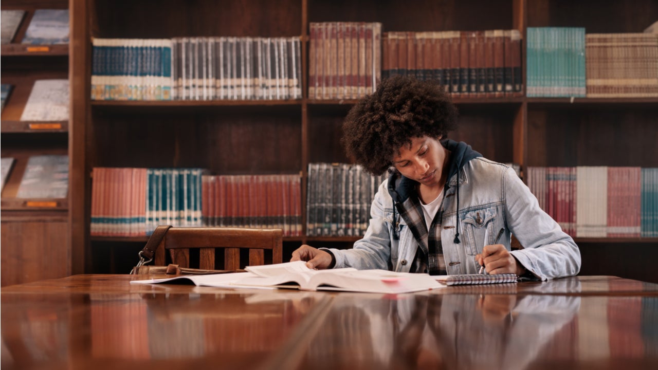 Young student studies in a college library