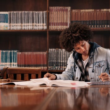 Young student studies in a college library