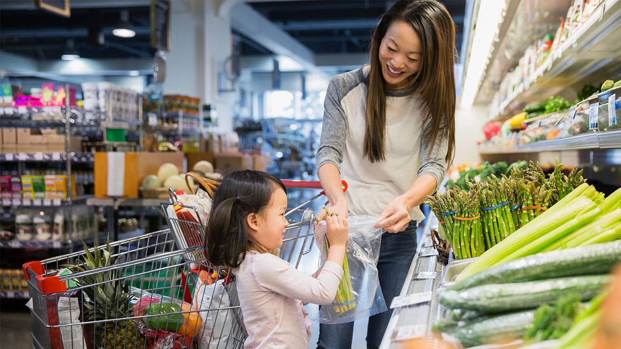 Mother and daughter shopping for vegetables