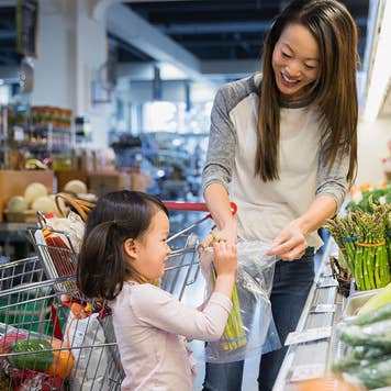 Mother and daughter shopping for vegetables