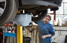 Mechanic looking under car