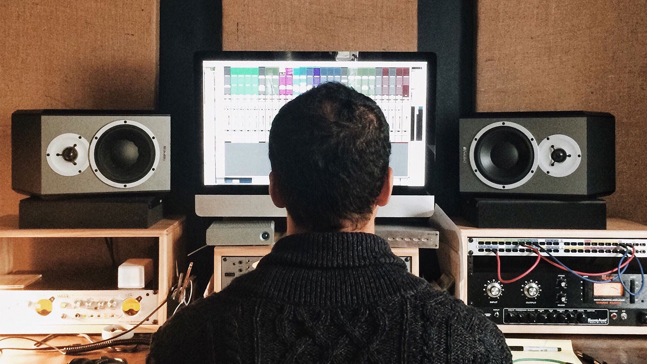 Man mixing music in home studio