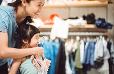 Mother and daughter clothing shopping