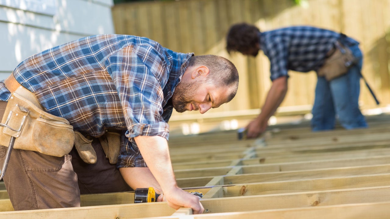 Men building house frame