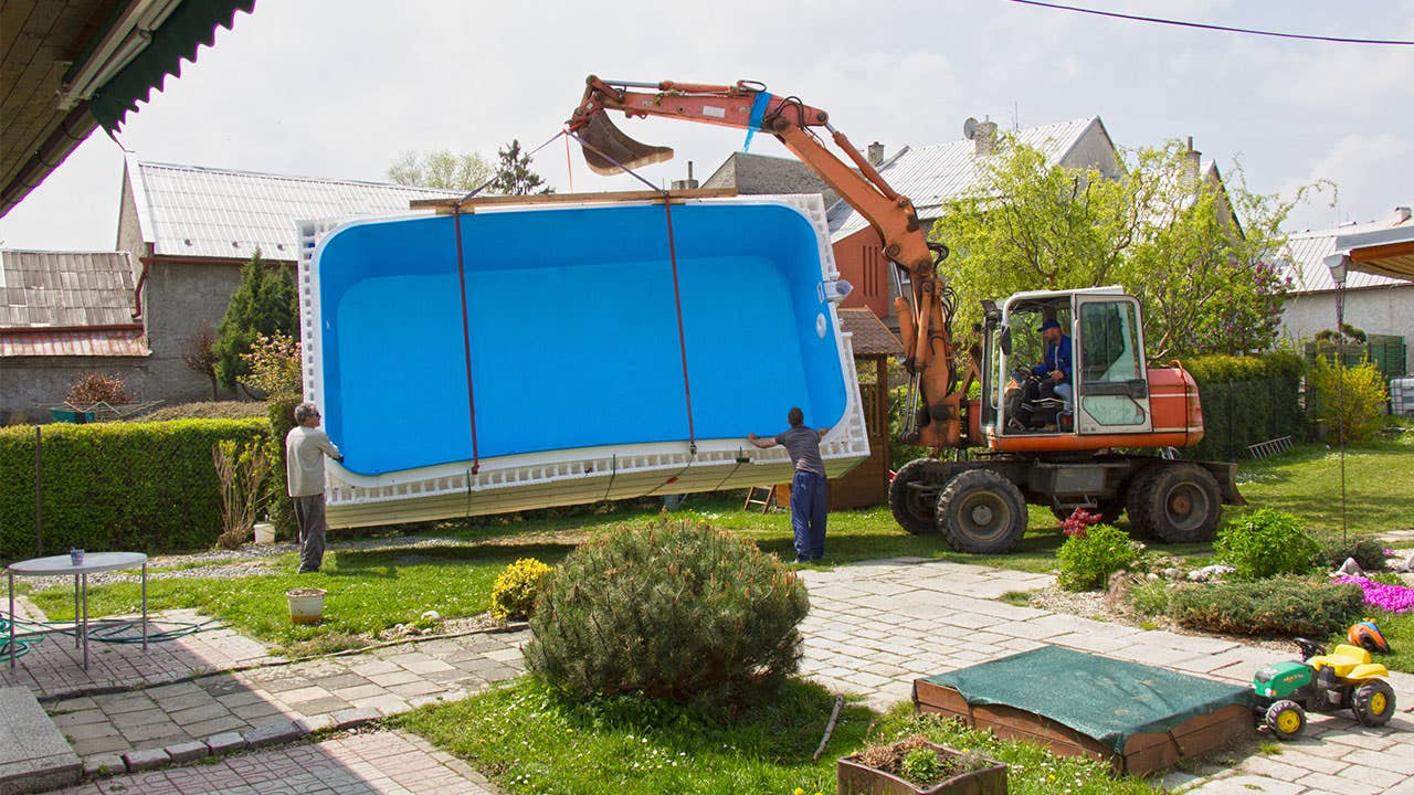 Forklift installing a swimming pool