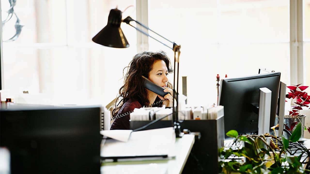 Woman talks on the phone in office