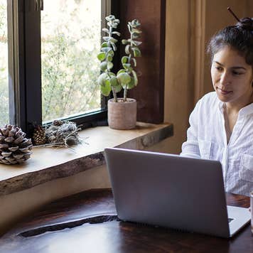 Woman on computer refinancing student loans