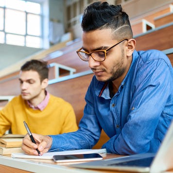 Students study in a college lecture hall