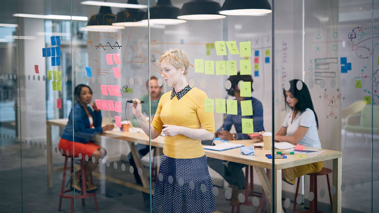 Woman writing in a sprint scrum team