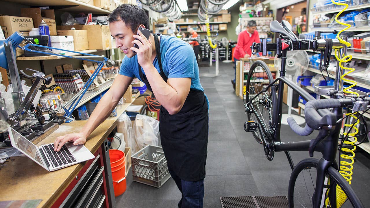 Latino man working in a bike shop