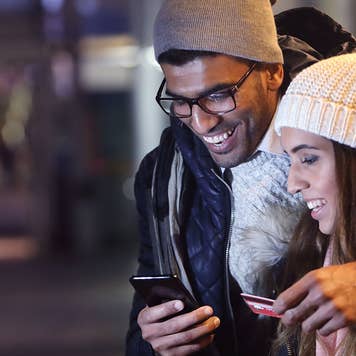 Couple checks cellphone in the cold