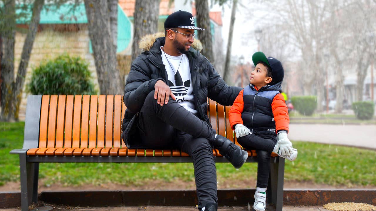 Father and son sitting on bench